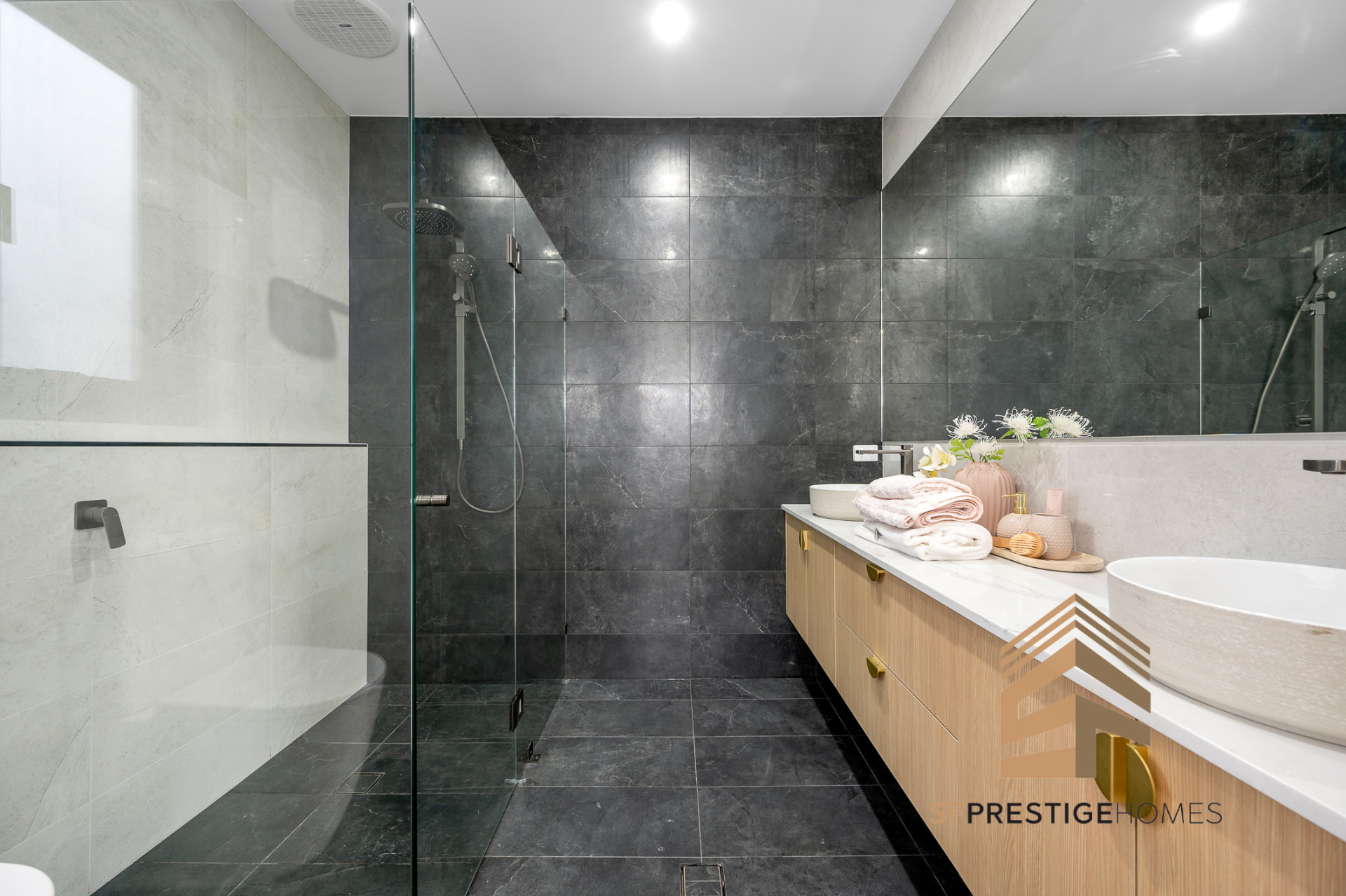 Custom home ensuite with stone-look tiling, timber vanity and stone benchtop